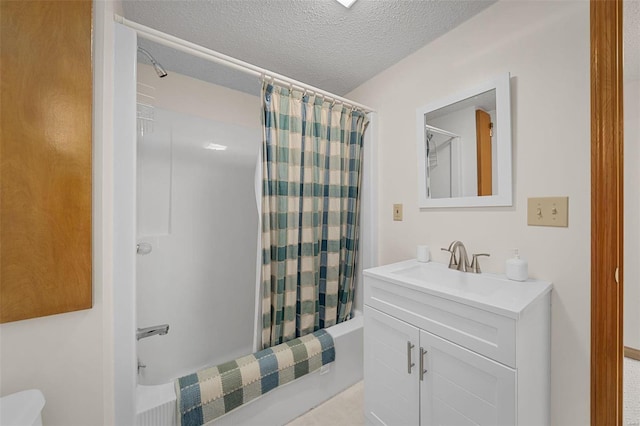 bathroom featuring vanity, shower / bathtub combination with curtain, and a textured ceiling