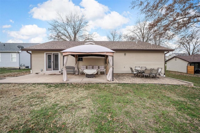 back of property featuring a gazebo, a yard, and a patio