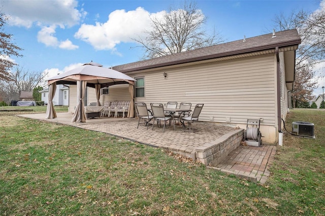 rear view of house featuring a gazebo, cooling unit, a patio area, and a yard