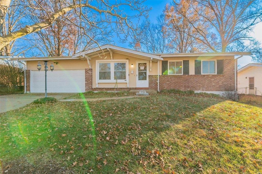 ranch-style home with a front yard and a garage