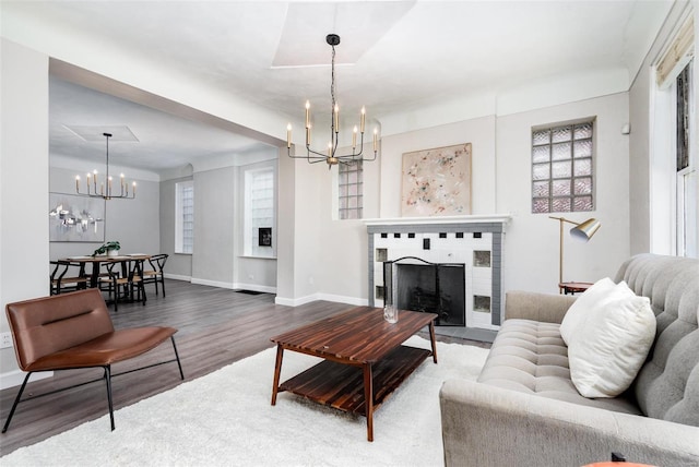 living room with wood-type flooring and a notable chandelier