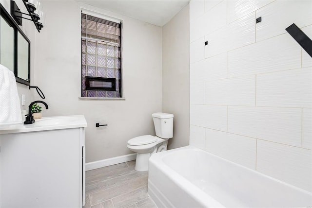 bathroom featuring vanity, hardwood / wood-style flooring, and toilet