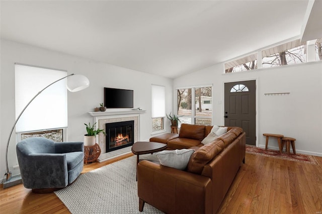 living room with light wood-type flooring and lofted ceiling