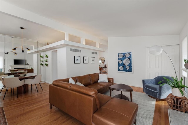 living room featuring vaulted ceiling and hardwood / wood-style floors