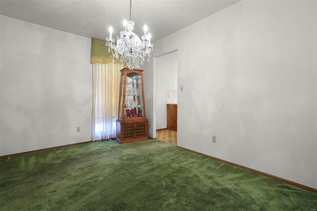 spare room featuring a notable chandelier and carpet floors