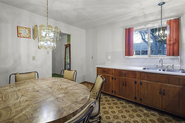 dining area with a notable chandelier and sink