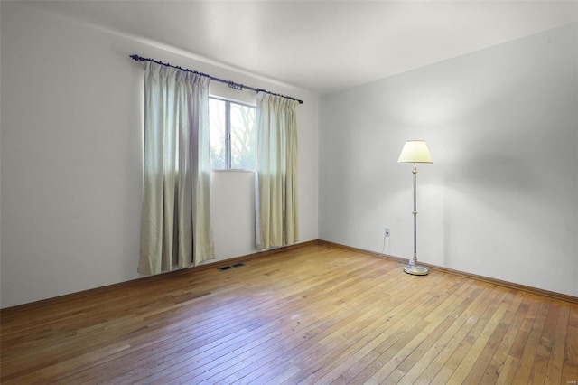 spare room featuring hardwood / wood-style floors