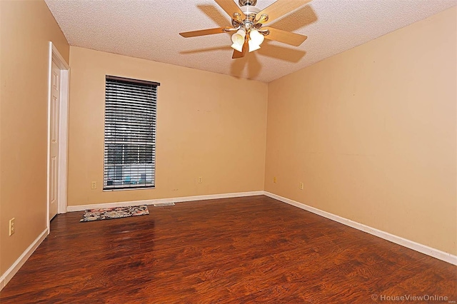 empty room featuring ceiling fan, wood-type flooring, and a textured ceiling