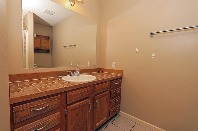 bathroom with tile patterned flooring and vanity