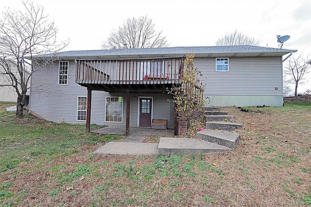 rear view of house featuring a deck and a patio area