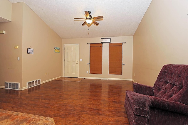 living area featuring ceiling fan, a textured ceiling, and hardwood / wood-style flooring