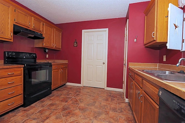 kitchen featuring black appliances, sink, and a textured ceiling