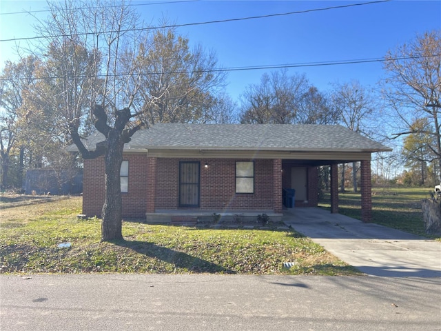 ranch-style home with a carport and a front lawn