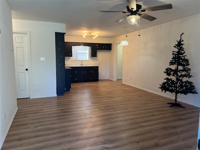 unfurnished living room featuring ceiling fan, dark hardwood / wood-style flooring, and sink