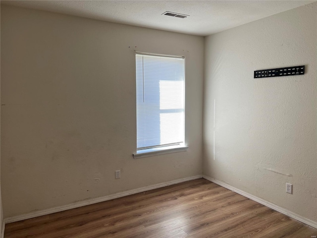 spare room with hardwood / wood-style flooring