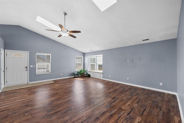 unfurnished living room with dark hardwood / wood-style floors, lofted ceiling with skylight, and ceiling fan