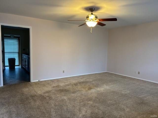 unfurnished room featuring dark carpet