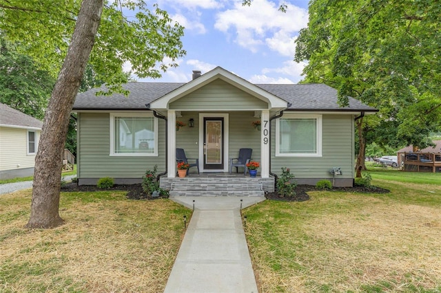 bungalow-style home featuring a front yard