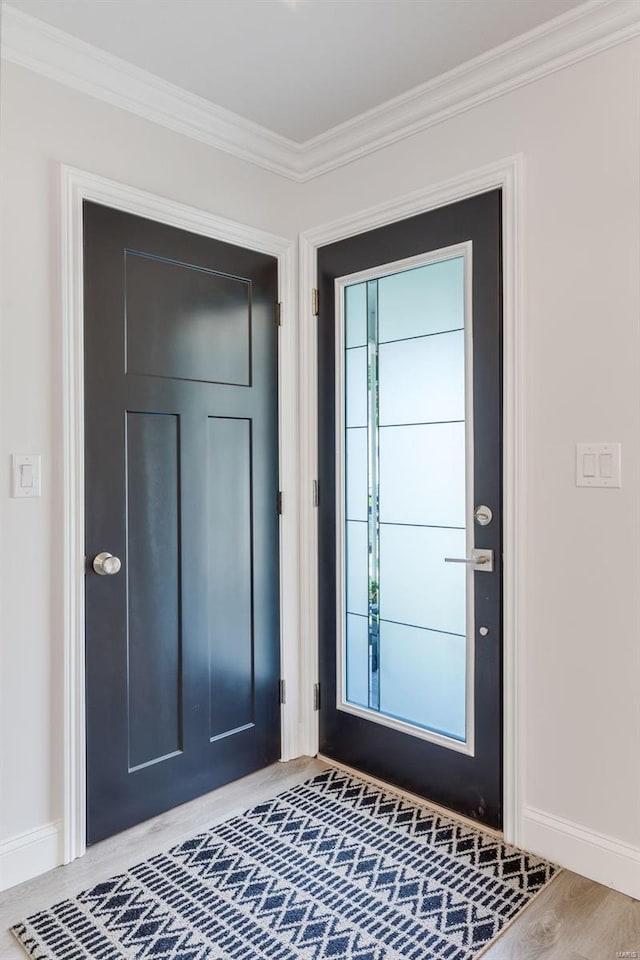 doorway to outside featuring hardwood / wood-style flooring and crown molding