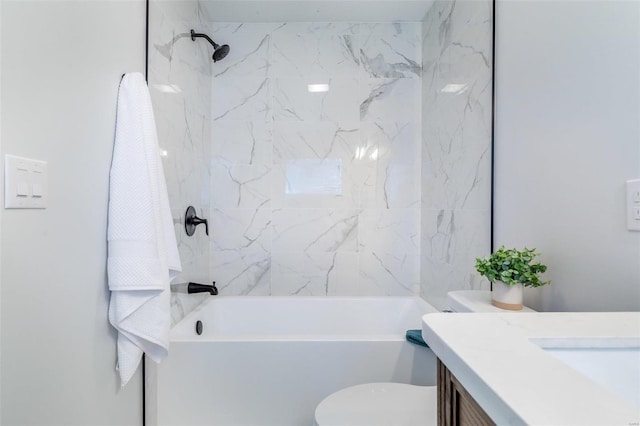 full bathroom featuring vanity, toilet, and tiled shower / bath combo