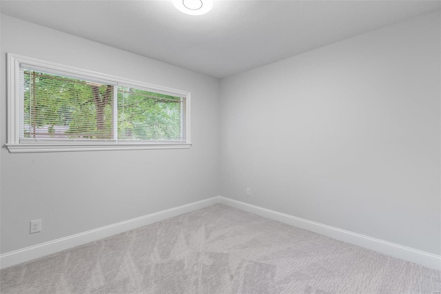 carpeted empty room with plenty of natural light