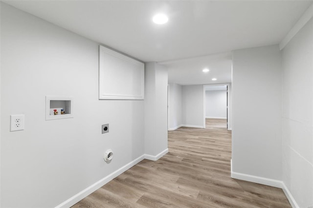 washroom with electric dryer hookup, hookup for a washing machine, and light wood-type flooring