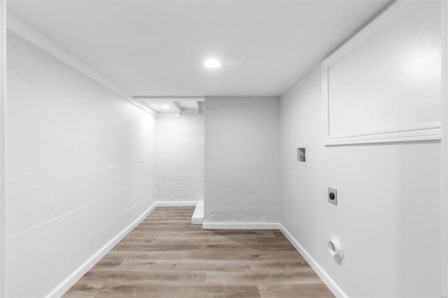 washroom featuring electric dryer hookup, light hardwood / wood-style floors, and hookup for a washing machine