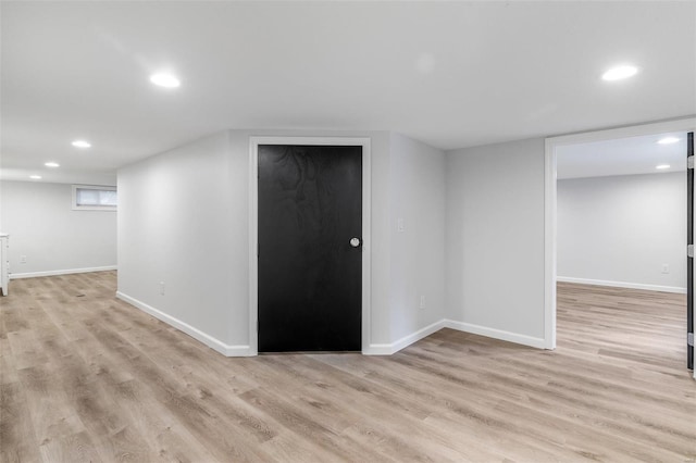 basement with light hardwood / wood-style floors