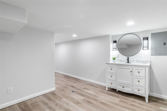 interior space with electric panel, hardwood / wood-style floors, and vanity