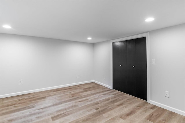 unfurnished bedroom with light hardwood / wood-style floors and a closet