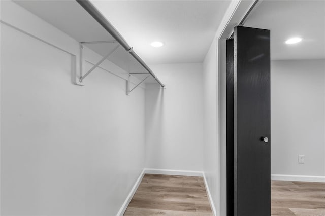 walk in closet featuring light hardwood / wood-style floors