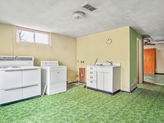 clothes washing area featuring washer and clothes dryer and sink