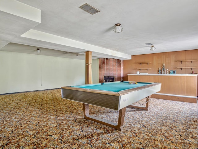 rec room featuring a fireplace, a textured ceiling, wooden walls, and billiards