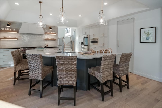 kitchen featuring white cabinets, a breakfast bar area, and a large island