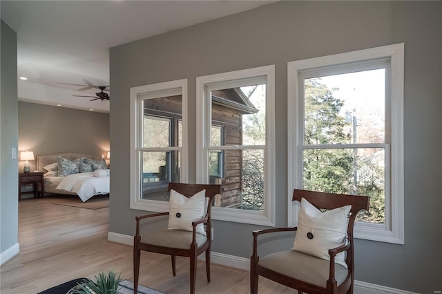 sitting room featuring light hardwood / wood-style flooring and ceiling fan