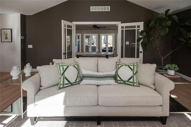 living room with ceiling fan and lofted ceiling