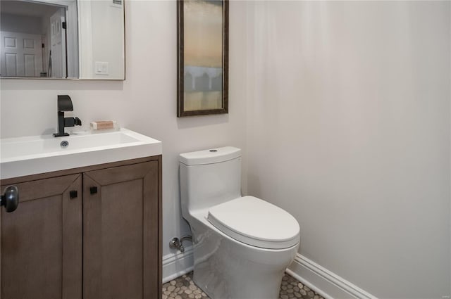 bathroom featuring tile patterned flooring, vanity, and toilet