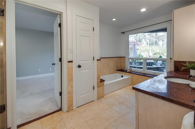 bathroom with vanity, tile patterned floors, and a bathing tub