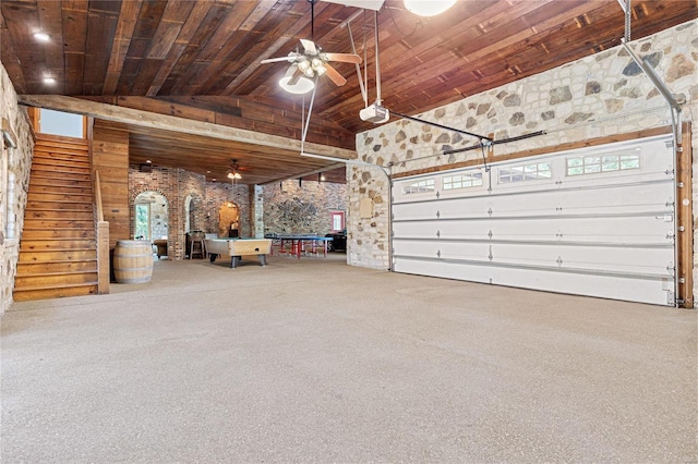 garage featuring ceiling fan, wooden ceiling, and a garage door opener