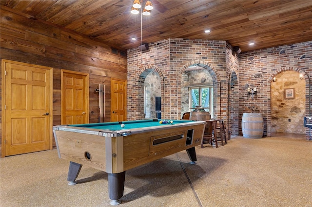 rec room with wood walls, pool table, light colored carpet, wood ceiling, and brick wall