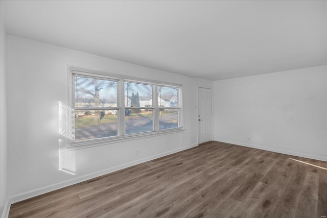 unfurnished room featuring hardwood / wood-style flooring