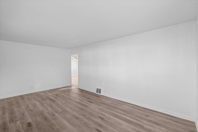 empty room featuring ceiling fan and light wood-type flooring