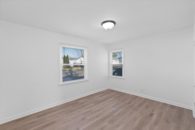 unfurnished room featuring plenty of natural light and light hardwood / wood-style flooring