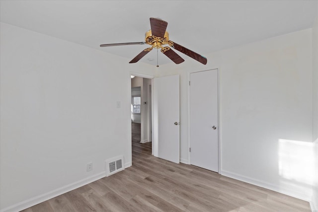 unfurnished bedroom featuring a closet, light hardwood / wood-style flooring, and ceiling fan