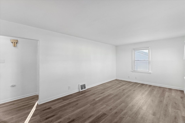 spare room featuring dark hardwood / wood-style floors