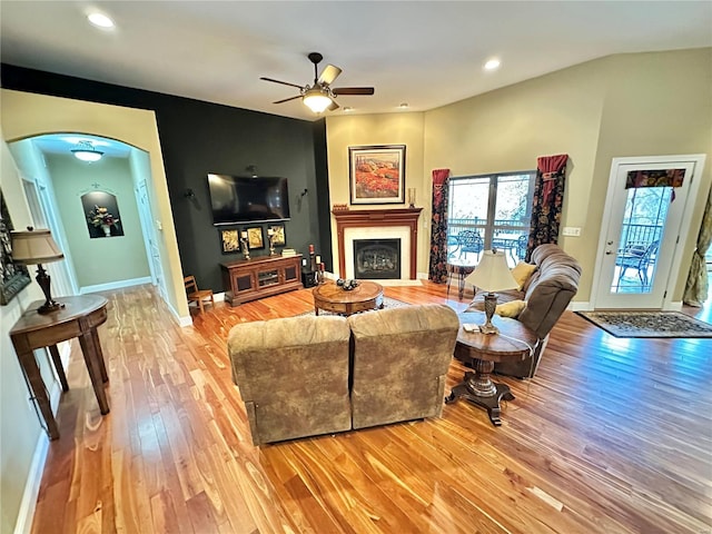 living room featuring light hardwood / wood-style floors and ceiling fan