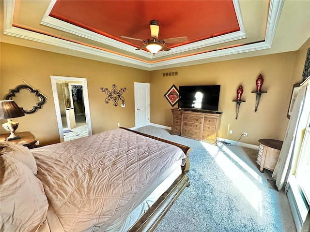 bedroom featuring a tray ceiling, ceiling fan, and ornamental molding