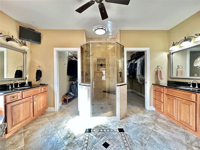 bathroom featuring vanity, walk in shower, and ceiling fan