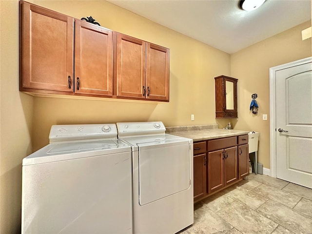 washroom featuring washer and dryer and cabinets