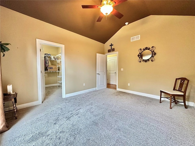 bedroom with carpet flooring, a spacious closet, ceiling fan, lofted ceiling, and a closet